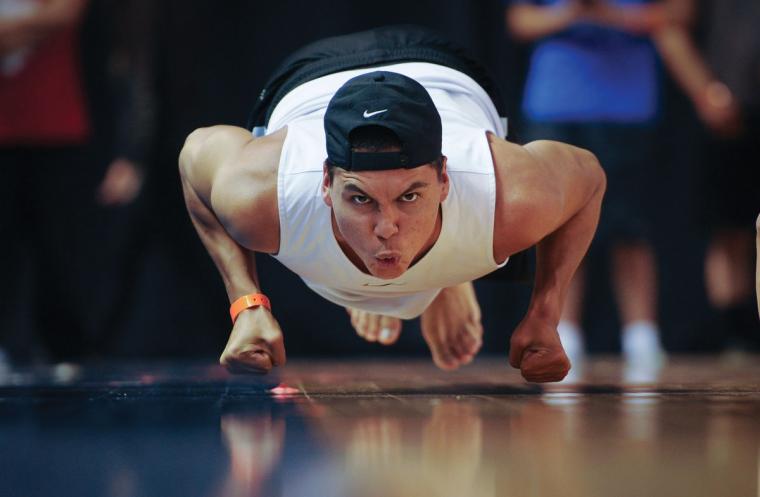 An athlete hops across the floor on his knuckles, moving like a seal