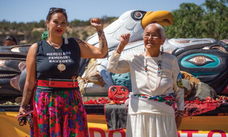 Nicole Martin and Rose Yazzie standing in front of the totem pole