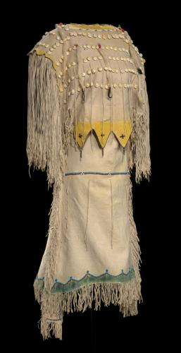 Kiowa woman’s cream-colored, fringed buckskin dress with glass and metal beads