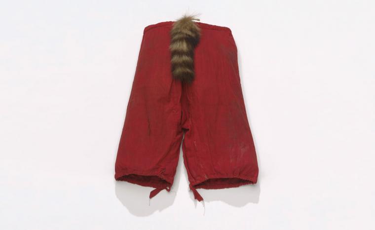 A man's stickball pants with a raccoon tail