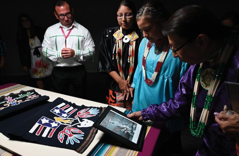 Iowa tribal members Joyce, Gabriella, Shayla and Eugene Big Soldier view a breechcloth