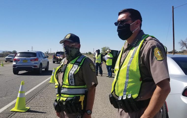 Phillip Francisco and another police officer at a roadblock during the COVID-19 on the Navajo Nation