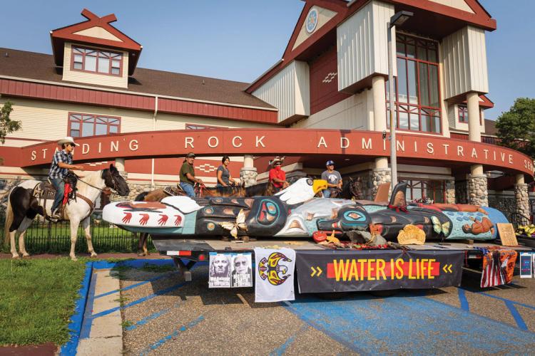 Standing Rock Sioux tribal members escort the totem pole to their Water is Life event