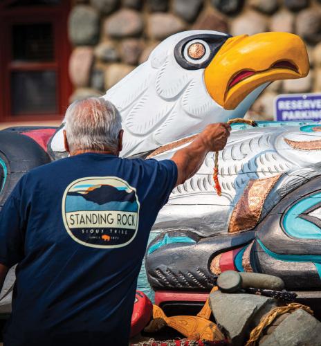 A tribal elder blesses the totem at the Standing Rock Sioux Nation’s Government Office.