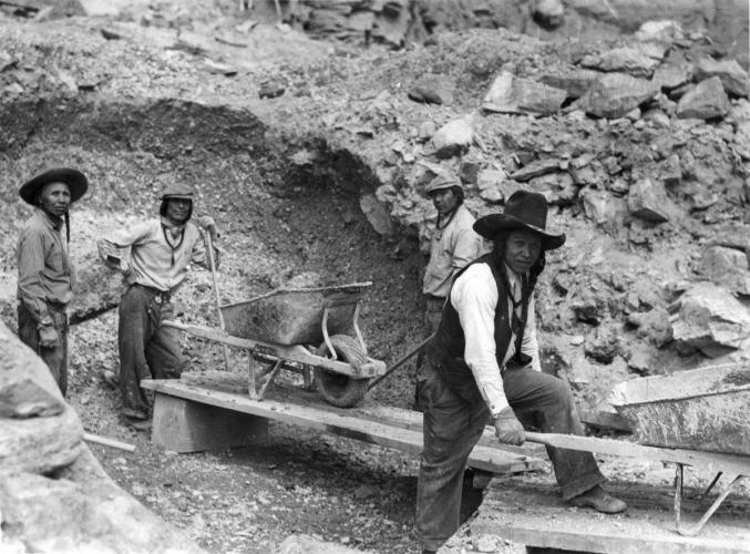 Members of the Confederated Salish and Kootenai Tribes moving dirt to build what was then the Kerr Dam.