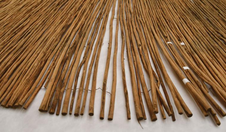 A mat with loose wood rods taped together.