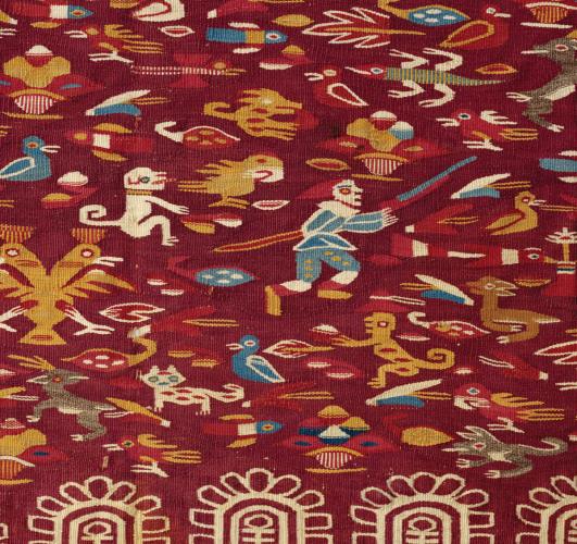 Detail of a red wedding manta with embroidered animal and human characters.