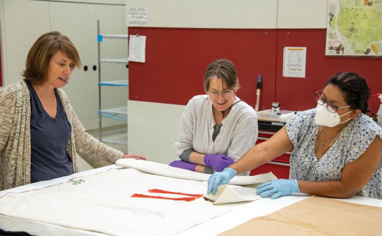 Conservators viewing Zapotec clothing