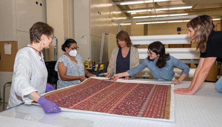 Conservators at the NMAI Cultural Resources Center design housing for a 500-year-old Inka wedding manta decorated with animal and human figures.