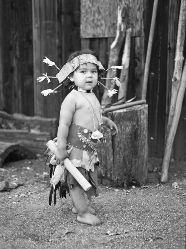 Black and white image of a young boy in dance regalia.