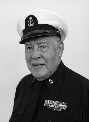 A black and white portrait of an older veteran wearing a marine uniform.