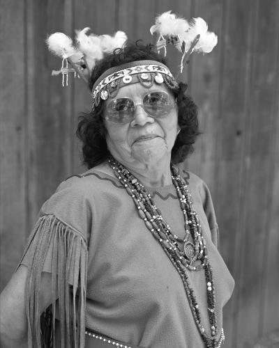 A black and white portrait of a woman in regalia.