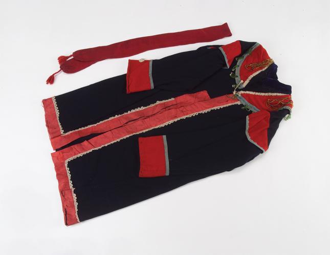 A black wool coat with red accents and its red silk sash 