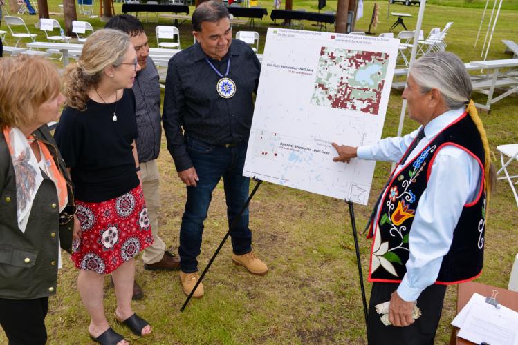 A council member points to a map of recently purchased lands.