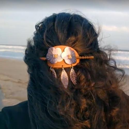 A woman wears a hairpiece made of quahog shells.