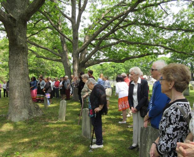 The Sisters of St. Joseph and members of the Shinnecock Nation attend a burial ceremony in a cemetary