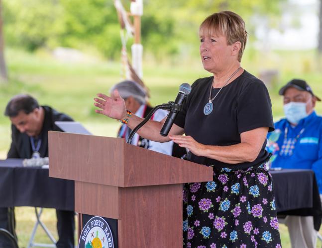 A woman speaks at a podium.