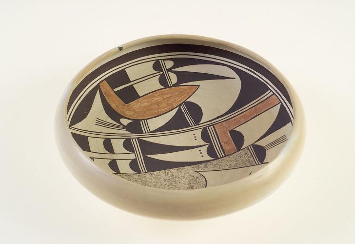 A shallow ceramic bowl with black and brown designs