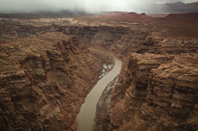 A river winds through a brown canyon