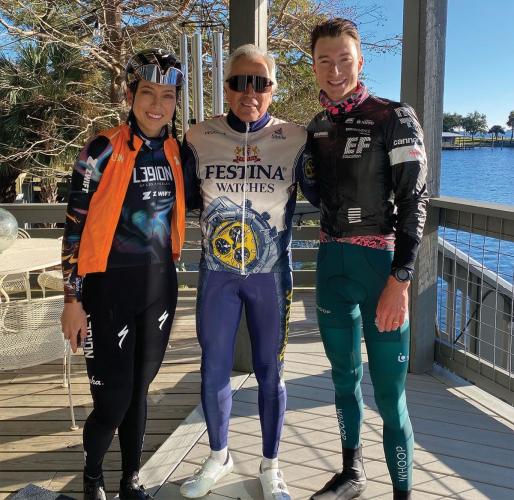 A photo of three people in cycling outfits