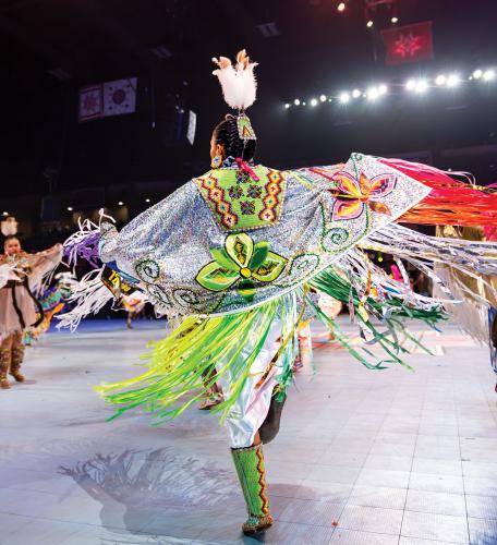 A female dancer wearing a fringed shawl