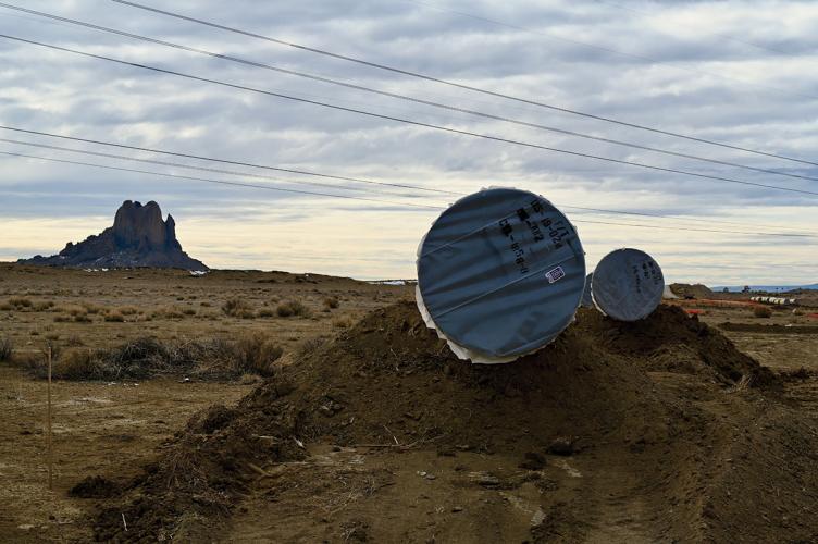 A photograph of pieces of pipeline nestled in the New Mexico landscape