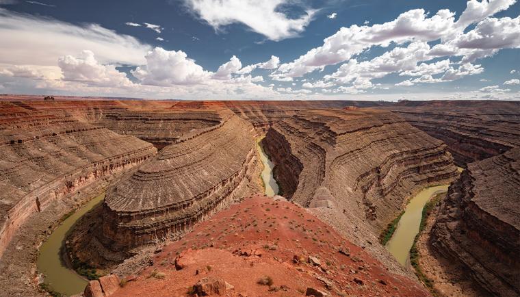 A photograph of a river winding through a red canyon