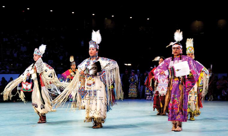 Two female buckskin dancers and one female cloth dancer