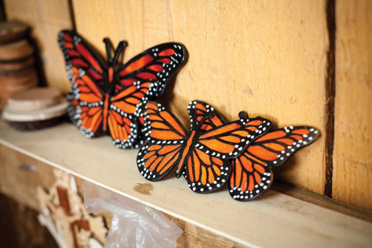 Painted monarch butterfly decorations on a shelf