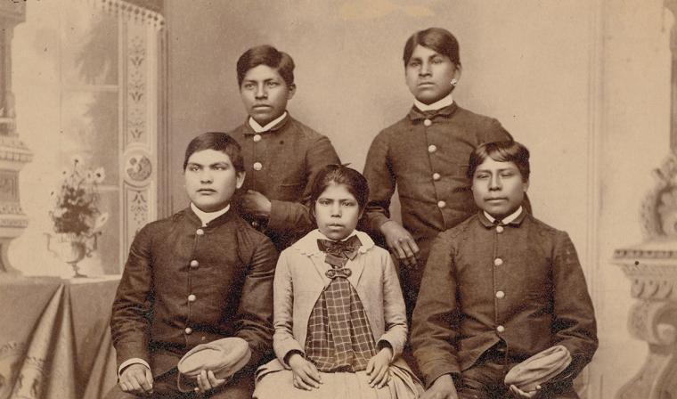 A sepia photograph of five Akimel O'Odham students in a formal setting