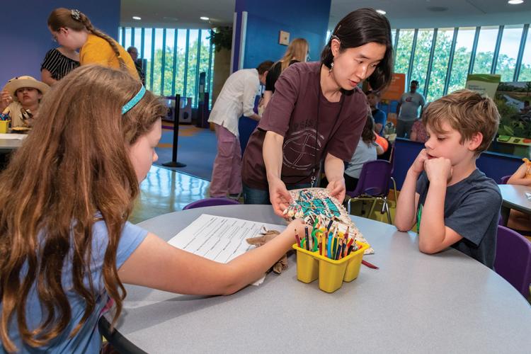 Sally Gunhee Kim shows samples of smoked hide to children