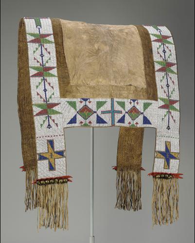 A brown and white horse blanket with green, red, blue and yellow geometric designs