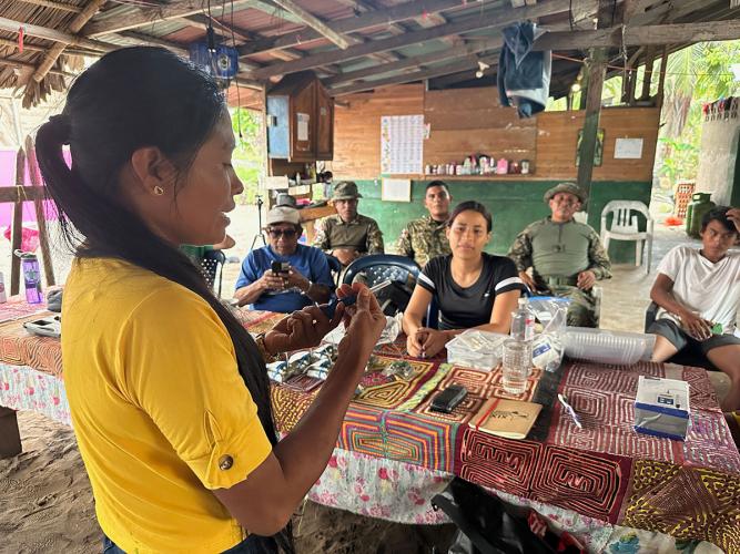 A volunteer shows others how to use a microchip tag