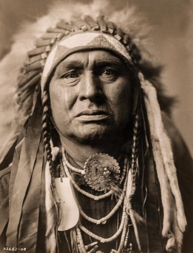 Antique portrait of a man wearing a feather headdress