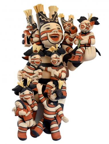 Clay sculpture of a storyteller surrounded by seven babies playing with toys