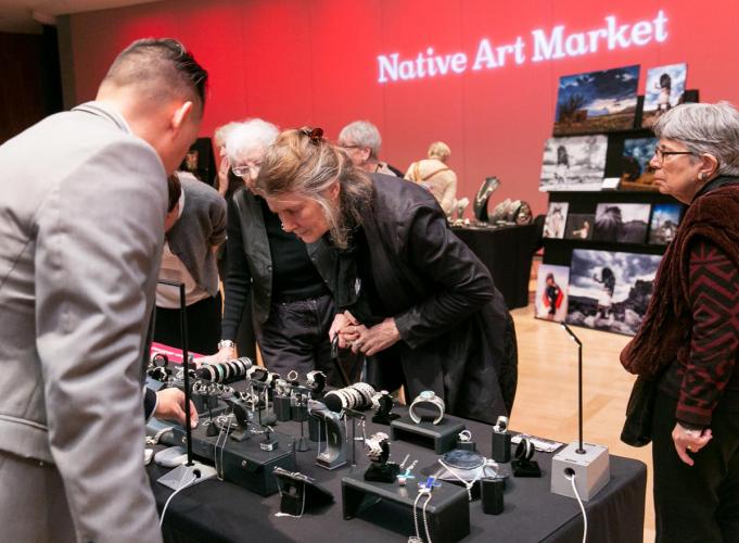 People look at the art pieces at the Native Art Market.