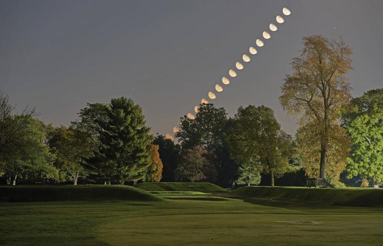 A timelapse photo of the moon rising over and aligning with ancient earthworks in Ohio