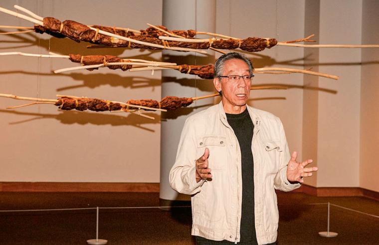 Lowe talks in front of his work.