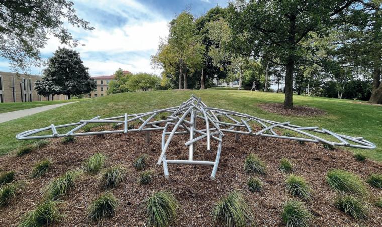 A large aluminum sculpture of a bird in flight