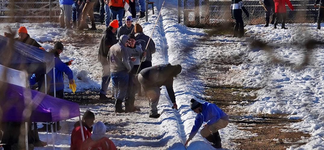 People on the Onondaga Nation dig a track dug out of snow.