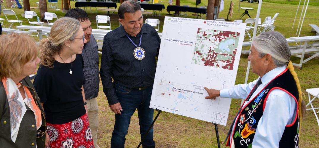 A council member points to a map of recently purchased lands.