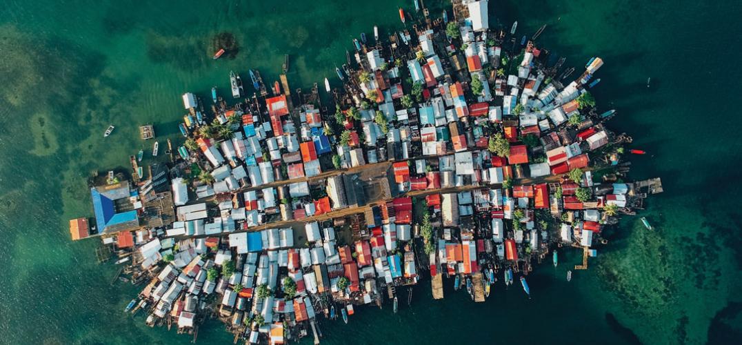 An aerial view of a small island completely covered with colorful buildings