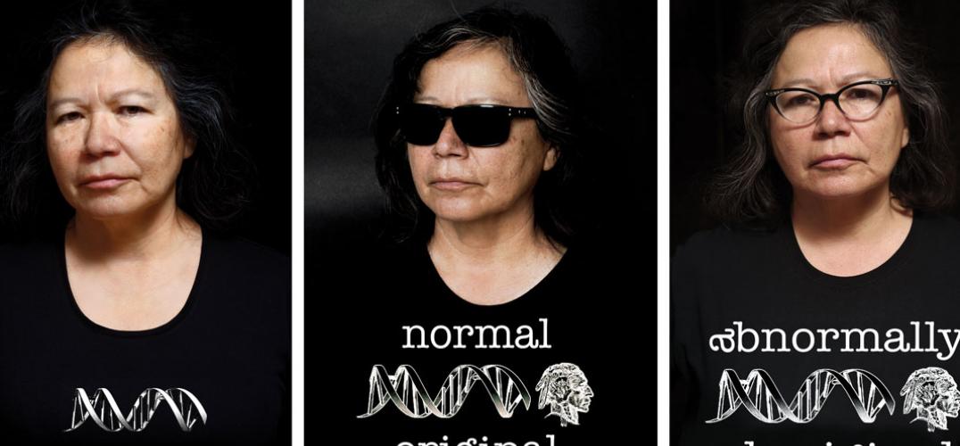 Three photographs of artist Shelley Niro wearing a black t-shirt. In the first, her t-shirt displays a strand of DNA. In the second, there is DNA and a figure wearing a headdress, with the words "Normal Original." In the third, the words are changed to "Abnormally Aboriginal."