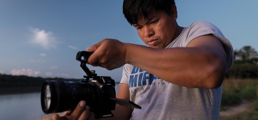 Peregrino Shanocua Chaeta holds a video camera 