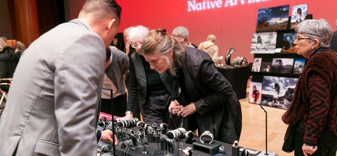 People look at the art pieces at the Native Art Market.