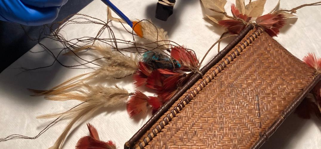 A gloved hand gently removes crystals from delicate artifacts.