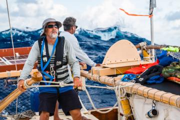 Dr. Craig Thomas at the helm of Hōkūle‘a