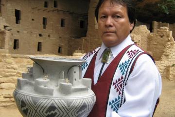 Joshua Madalena with Best of Show replica pottery of Cliff Palace. 2010, 14" x 18"