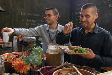 Vincent Medina and Louis Trevino plate food and serve customers at their cafe