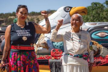 Nicole Martin and Rose Yazzie standing in front of the totem pole